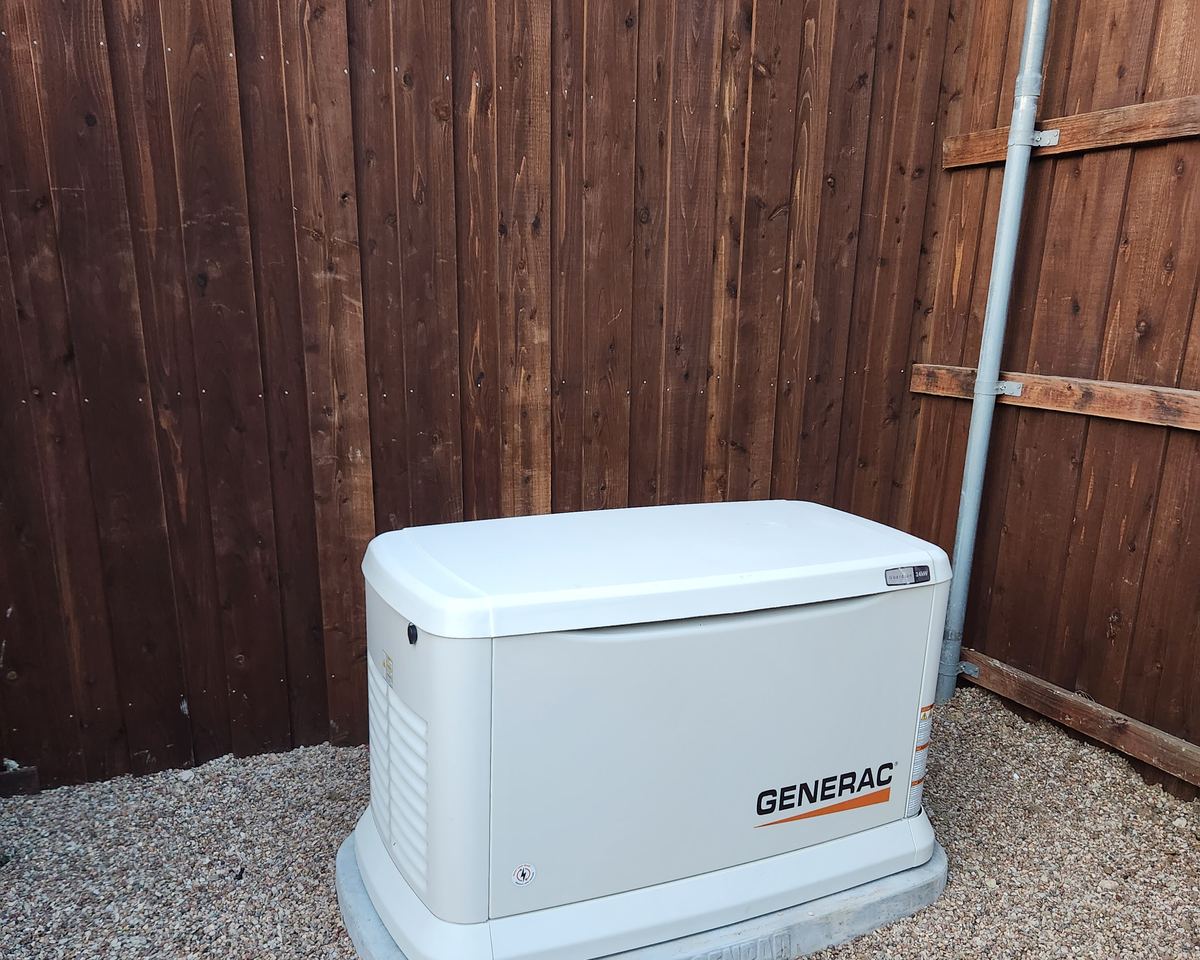 Generac standby generator installed on a concrete pad beside a Houston-area home