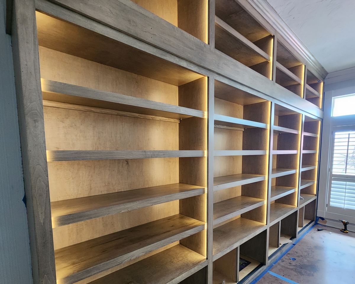 Custom built-in shelving with integrated LED accent lighting installed by Bright Solutions Electrical